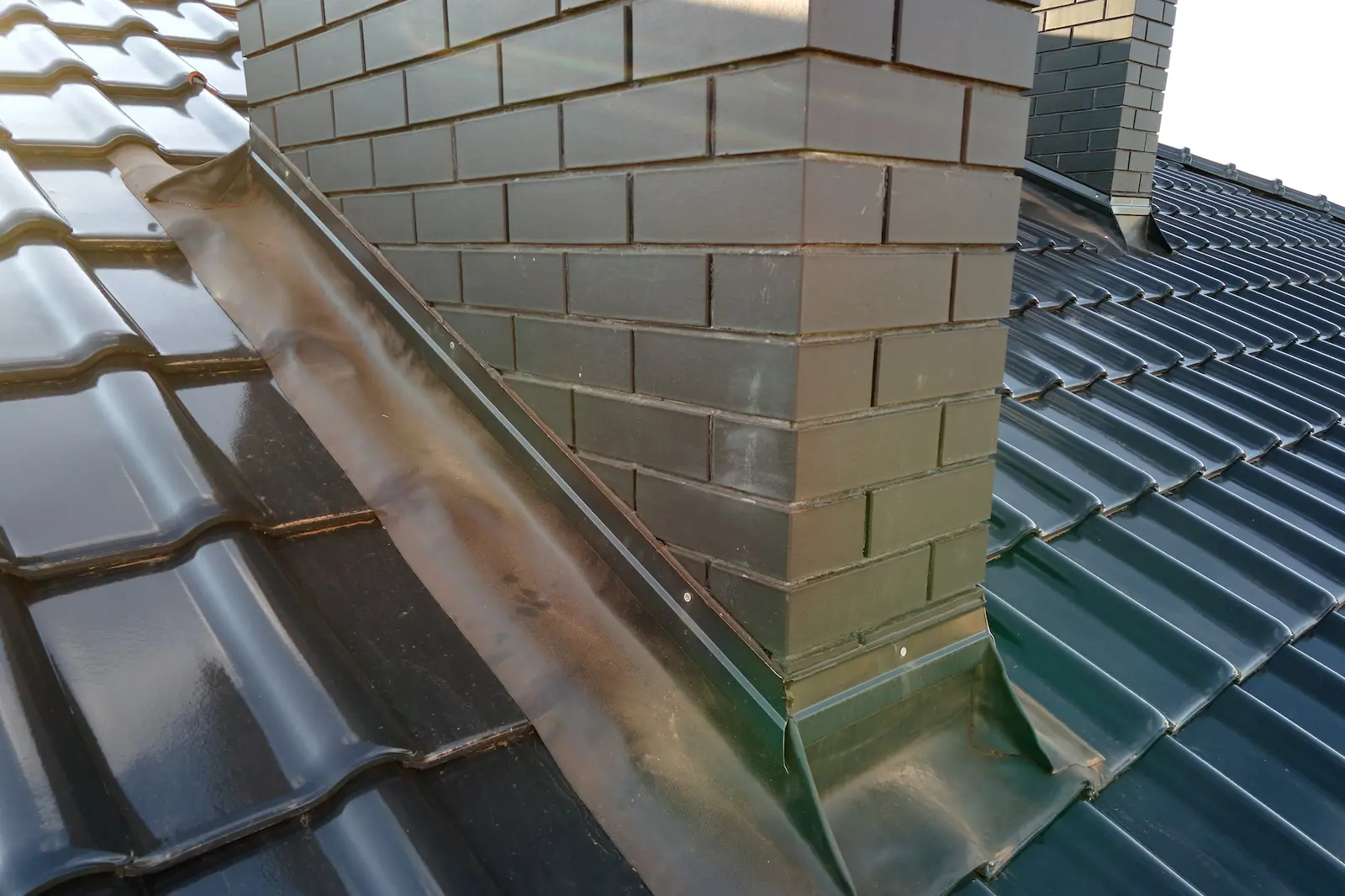 Close up of roof flashing around roof chimney in central florida