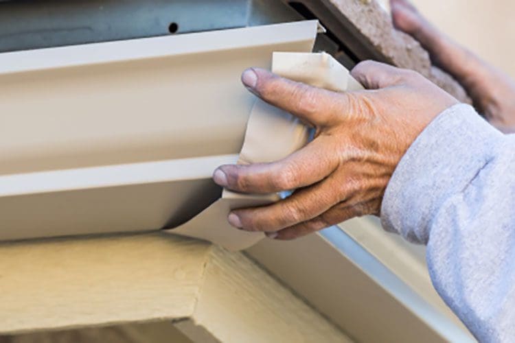person installing gutters