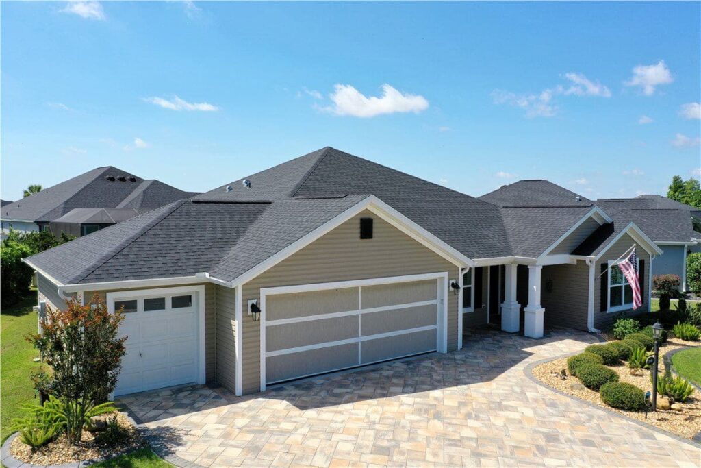 beige house with newly built asphalt shingle roof