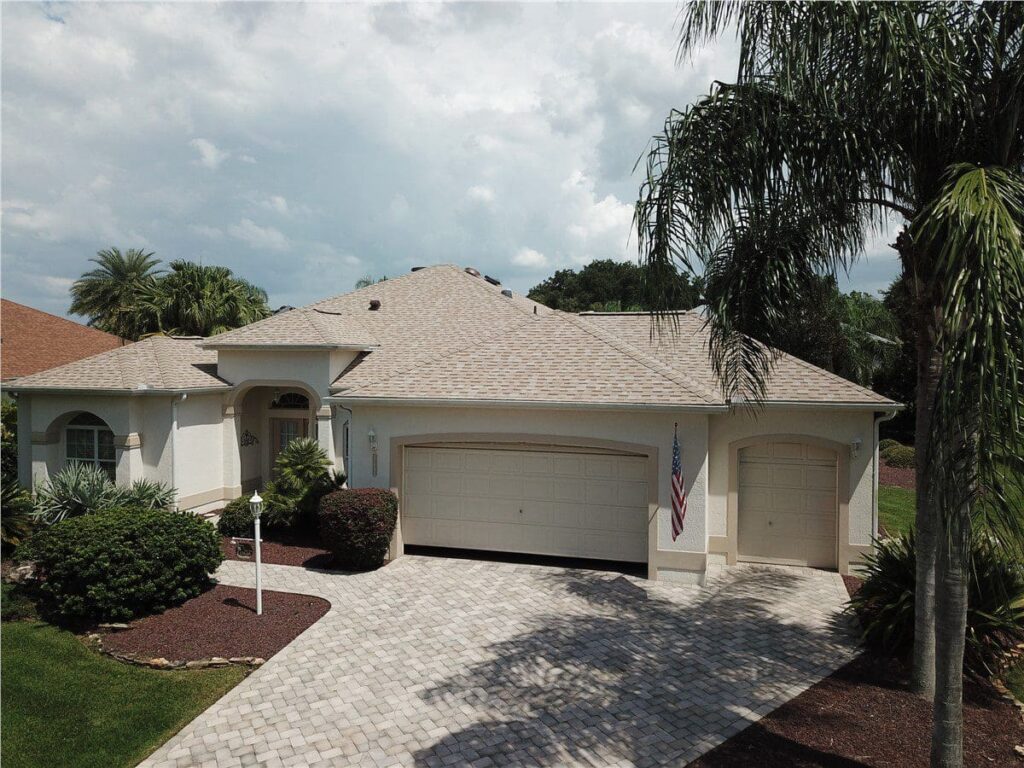 white house with gray asphalt shingle roof