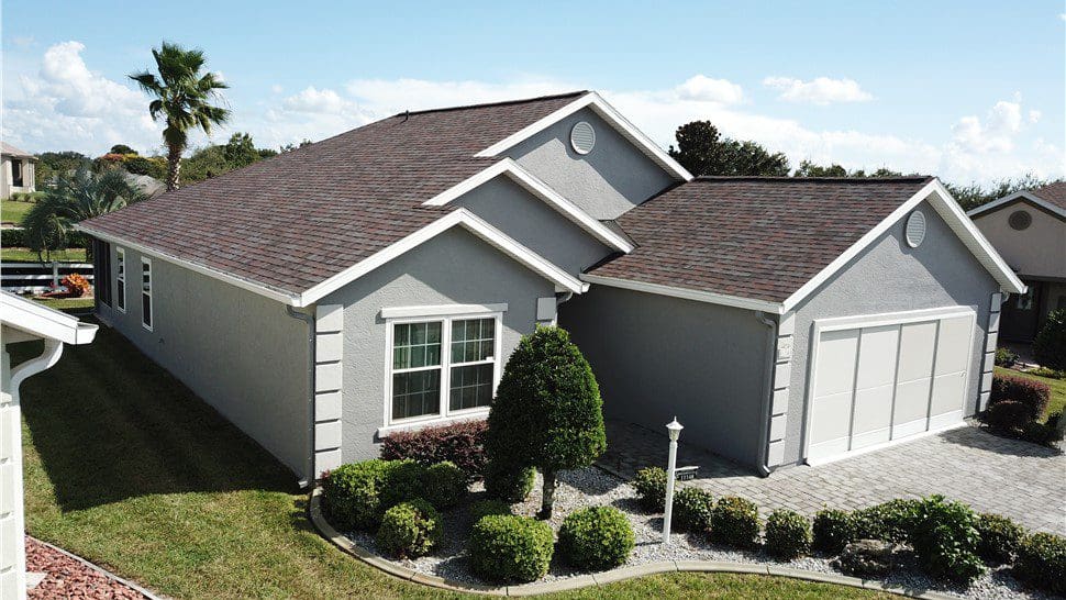 gray house with dark gray asphalt shingle roof