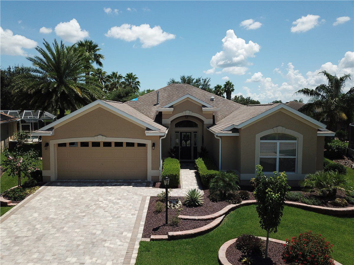 tan home with asphalt shingle roof