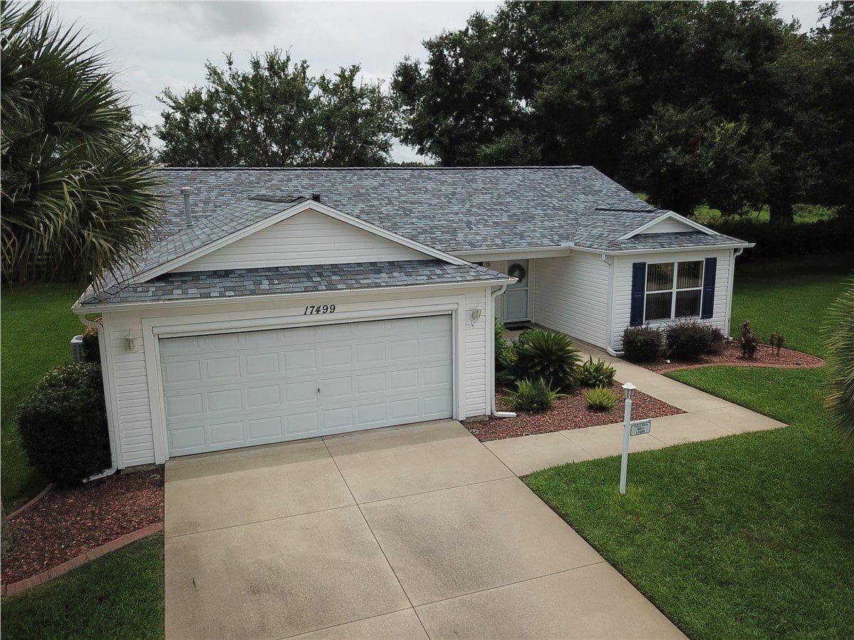 white house with multicolored asphalt shingle roof