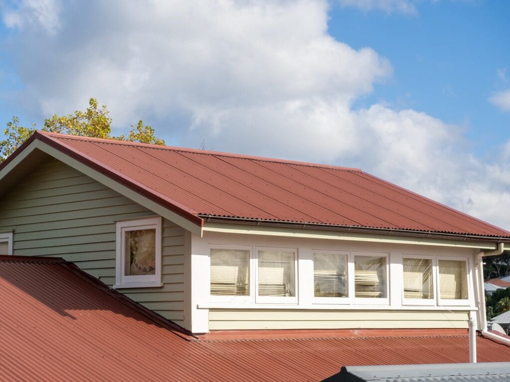 Close up of top of residential home in central florida with red metal roof