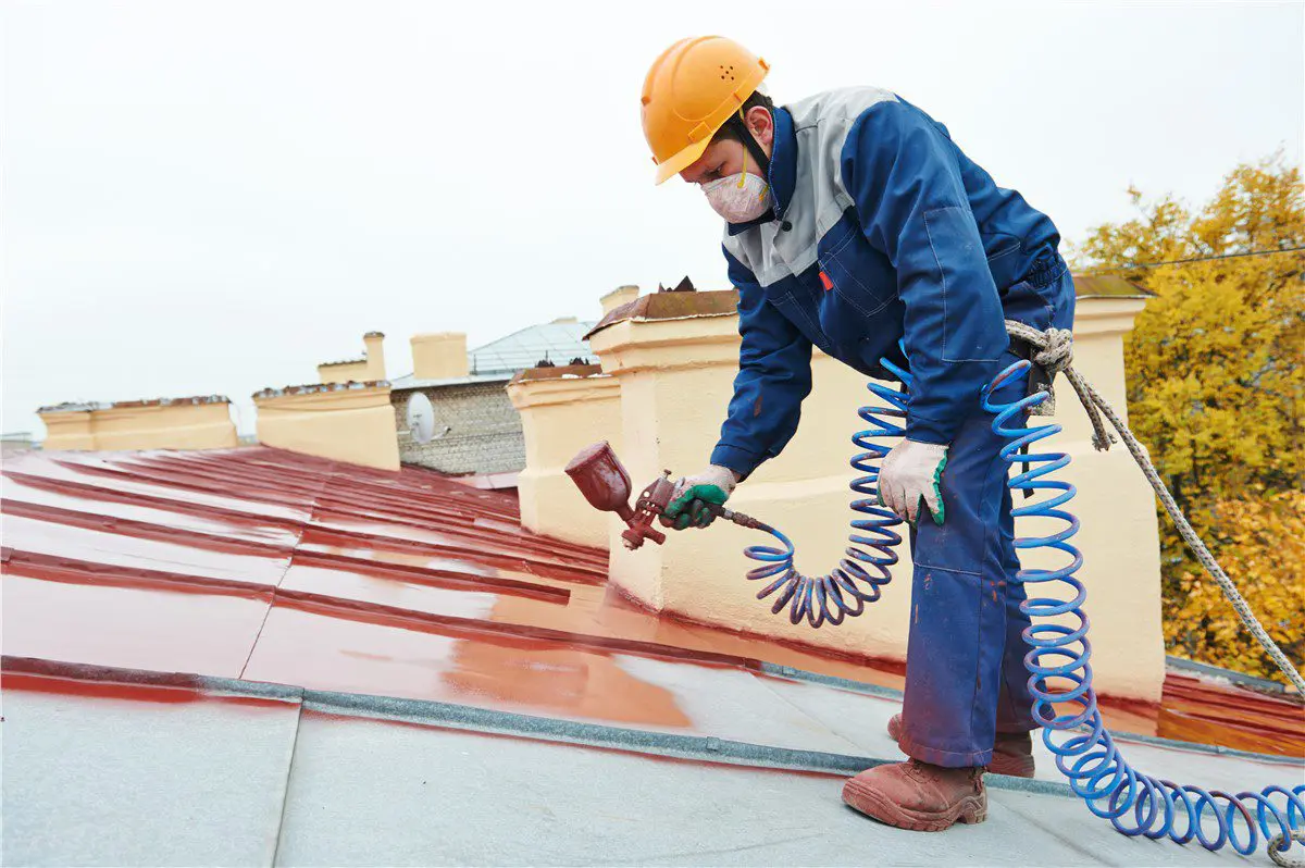 person spraying a roof