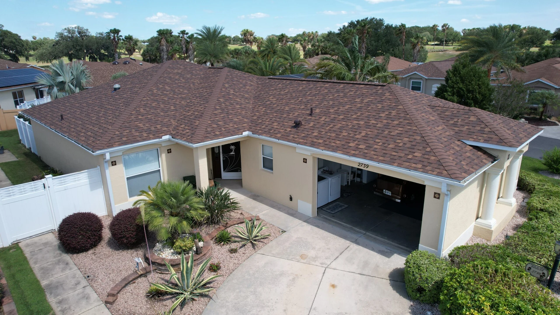 red asphalt shingle roof on a yellow house