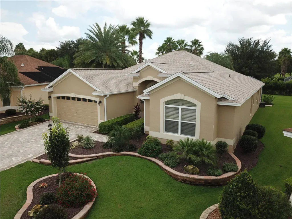 tan house with light gray asphalt shingle roof