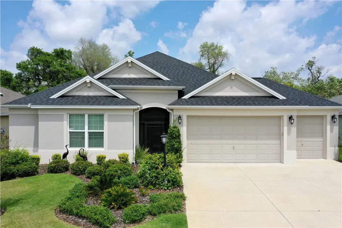 white house with dark gray asphalt shingle roof